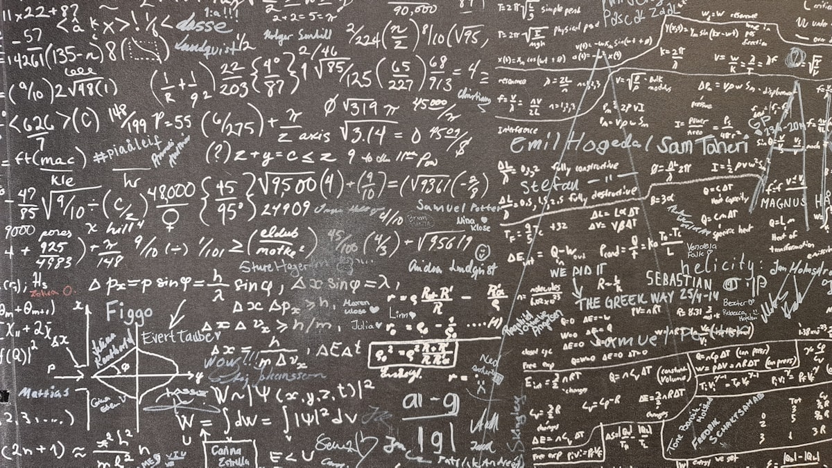 Math equations worked out on a chalkboard