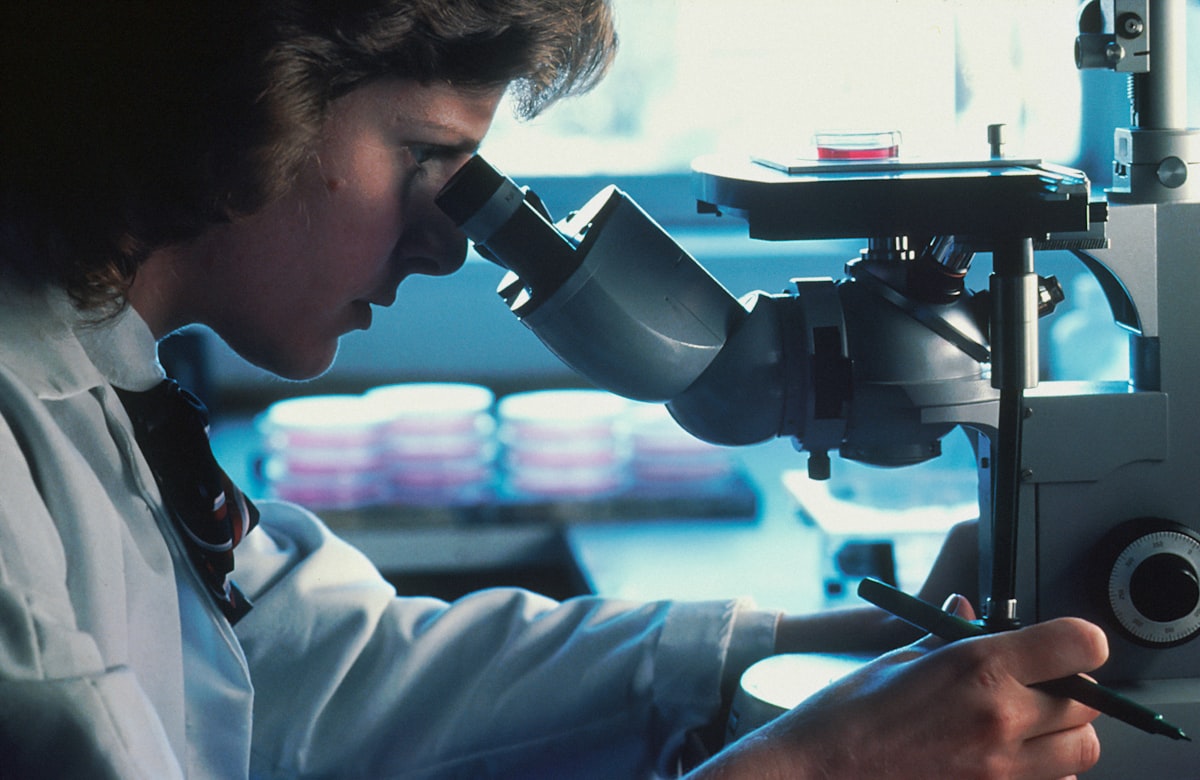 Student looking through a microscope in a lab