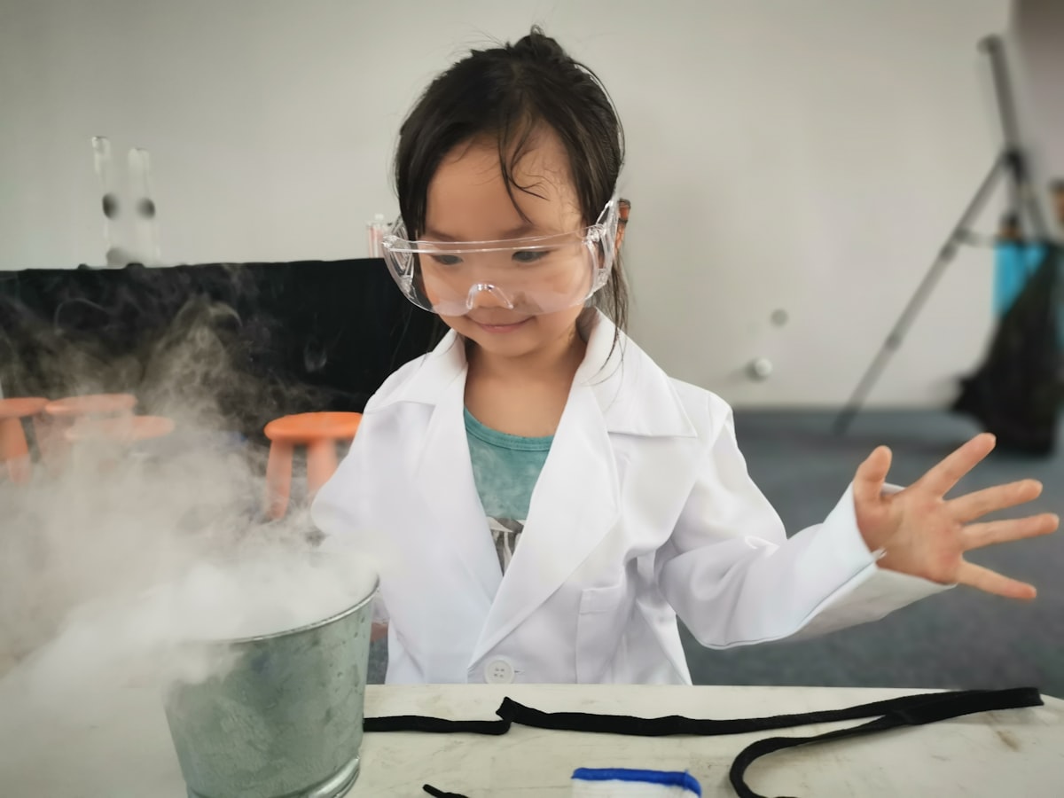 Student in safety goggles running a science experiment